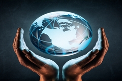 Image Hands holding a glowing digital globe representing sustainability and global responsibility